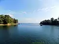Image 51Kaptai Lake is the largest man made lake in Bangladesh. It is located in the Kaptai Upazila under Rangamati District of Chittagong Division. The lake was created as a result of building the Kaptai Dam on the Karnaphuli River, as part of the Karnaphuli Hydro-electric project. The Kaptai Lake's average depth is 100 feet (30 m) and maximum depth is 490 feet (150 m).Photo Credit: Fahad Faisal