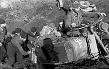 a black and white photograph of a group of soldiers pushing a motorcycle combination up a hillNipe 2011, p. 244.