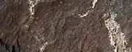 Close view of light-toned materials, as seen by HiRISE under HiWish program Light-toned materials have been associated with water.