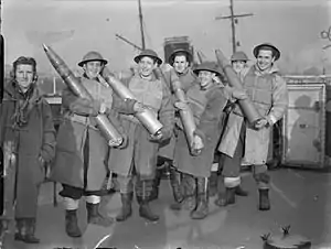 Gunners of V-class destroyer HMS Vivien displaying anti-aircraft rounds, 1940