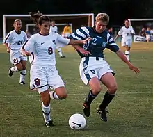 Image 9Mia Hamm (left) battles with German defender Kerstin Stegemann (from Women's association football)