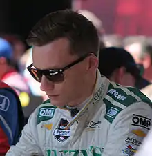 Driver Mike Conway, in uniform and dark glasses
