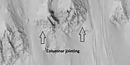 Close view of crater wall with columnar jointing labeled.  Picture taken with HiRISE.