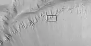 Crater wall with columnar jointing in the location of the box.  Columnar joints are easily seen in the enlarged image that follows.  Picture taken with HiRISE.