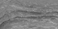 Close view of layers,  as seen by HiRISE under HiWish program. Some of the layers are breaking up into large blocks.