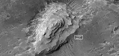 Close view of layered mound  in Crommelin crater, as seen by HiRISE.  Box indicates the size of a football field for scale.
