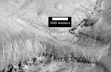 East Slope of Central Pit in Asimov Crater, as seen by HiRISE.  Click on image to see more details of the many gullies.