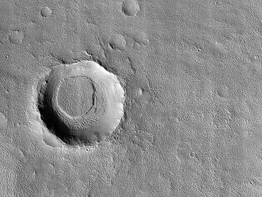 Crater with mesa. First the crater was formed. Later material was deposited in the area. That material was eroded all over, except in this crater.