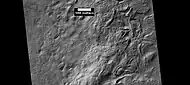 Surface showing large hollows of unknown origin, as seen by HiRISE under HiWish program