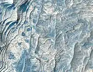 Close, color view of layers in Schiaparelli Crater, as seen by HiRISE under HiWish program. Dark sand is visible on some layers.