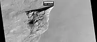 Wide view of triangular depression, as seen by HiRISE. The wall which faces the south pole contains ice in distinct layers that are visible in next image. Location is Hellas quadrangle.