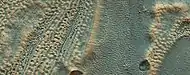 Close, color view of ice layers in crater in previous image, as seen by HiRISE under HiWish program.  Both, open and closed brain terrain are visible.