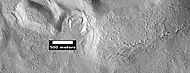 Dipping layers and layers of mantle, as seen by HiRISE under HiWish program.  The dipping layers look similar to layers of mantle.