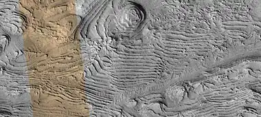 Layers, as seen by HiRISE.  Black strip in middle is due to a malfunction.  Colored strip is about 1 km across.