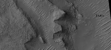 Layers in depression in crater, as seen by HiRISE under HiWish program A special type of sand ripple called Transverse aeolian ridges, TAR's are visible and labeled.