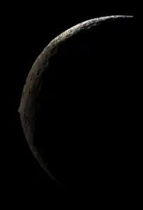 An image of Iapetus from its nightside that was photographed by an approaching Cassini, showing it as a slender crescent with its massive equatorial ridge clearly visible at the middle. This image was taken on September 10, 2007, at a distance of 83,000 kilometers (52,000 miles).