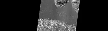 Close-up of surface of a lobate debris apron in Hellas quadrangle.  Note the lines that are common in rock glaciers on the Earth.