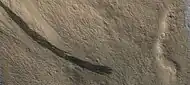 Dark slope streaks along a mesa wall, as seen by HIRISE.  Picture is about 1 km across.