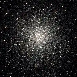 Thousands of white-ish dots scattered on a black background, strongly concentrated towards the center