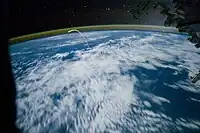 Long-exposure photo (1.6 seconds at f/2.8, ISO 10000) from the ISS in July 2011 of Space Shuttle Atlantis re-entry in which some stars are visible. In this image, the Earth is lit by moonlight, not sunlight.