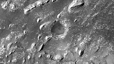 Crommelin crater showing layers in buttes and inside a small crater, as seen by CTX camera.  Note: this is an enlargement of a previous image of Crommelin crater.